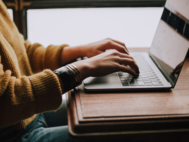 Woman typing on a laptop